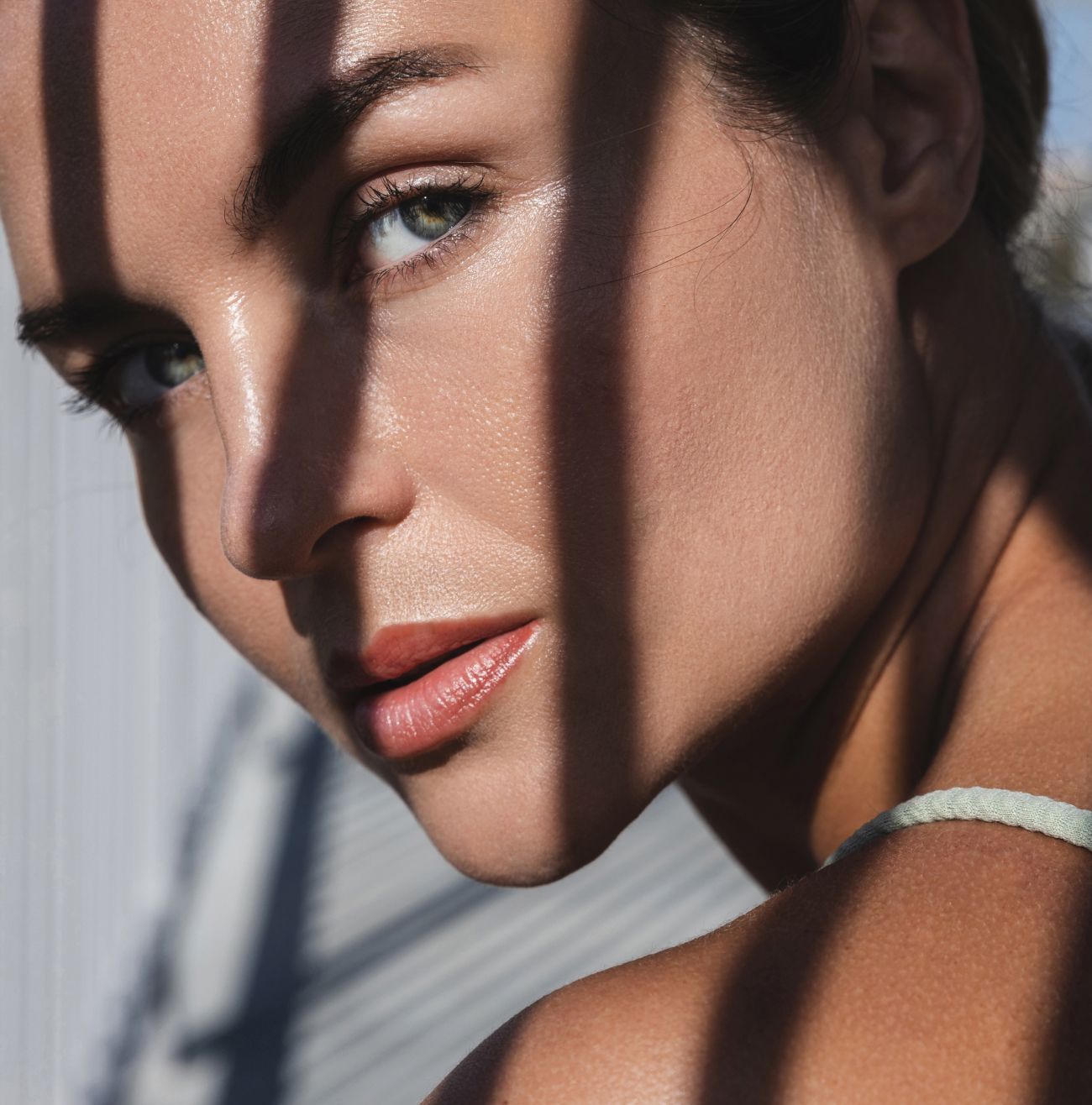 Woman’s face partially shadowed with natural light.