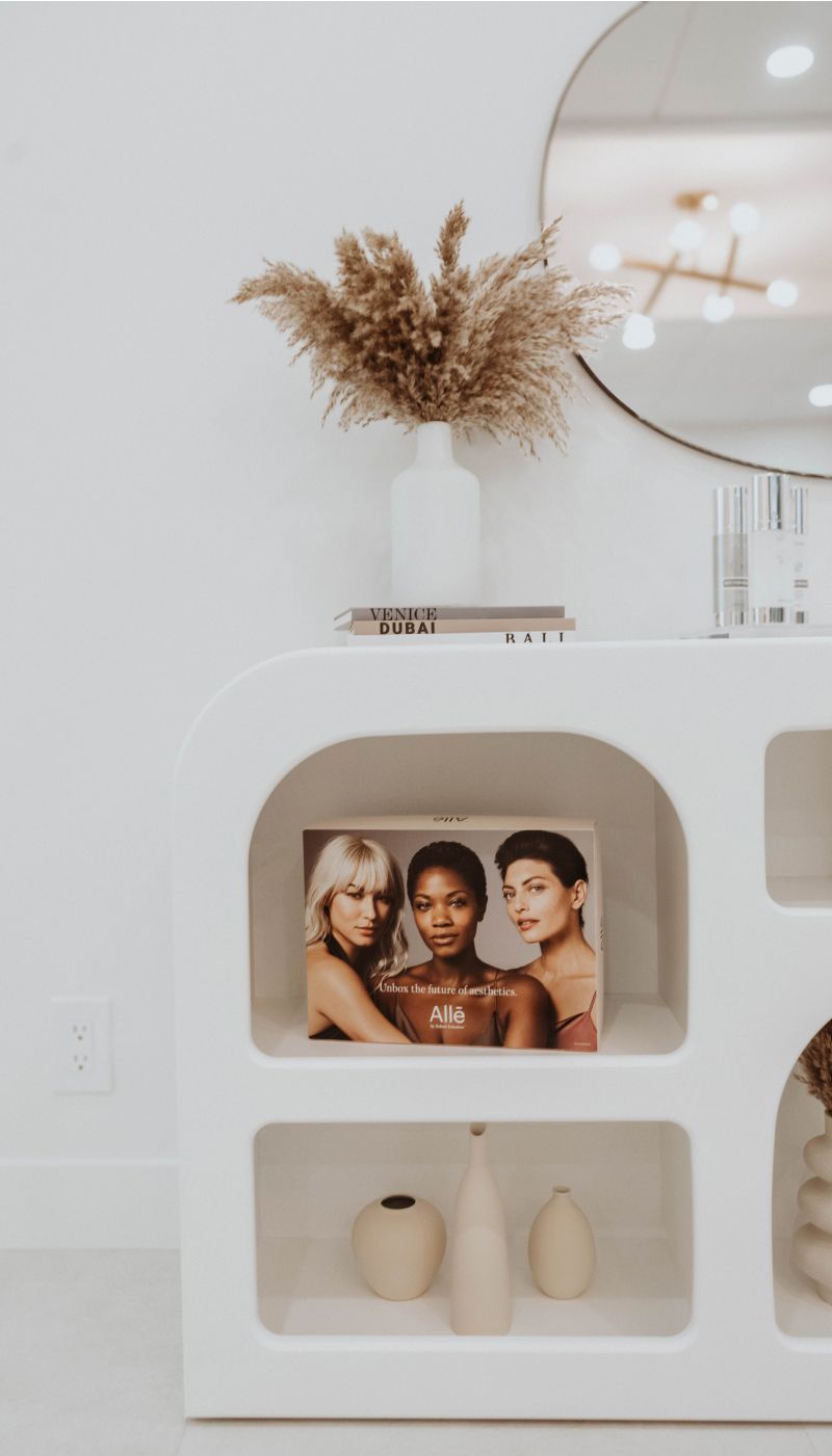 Decorative shelf displaying books and vases.