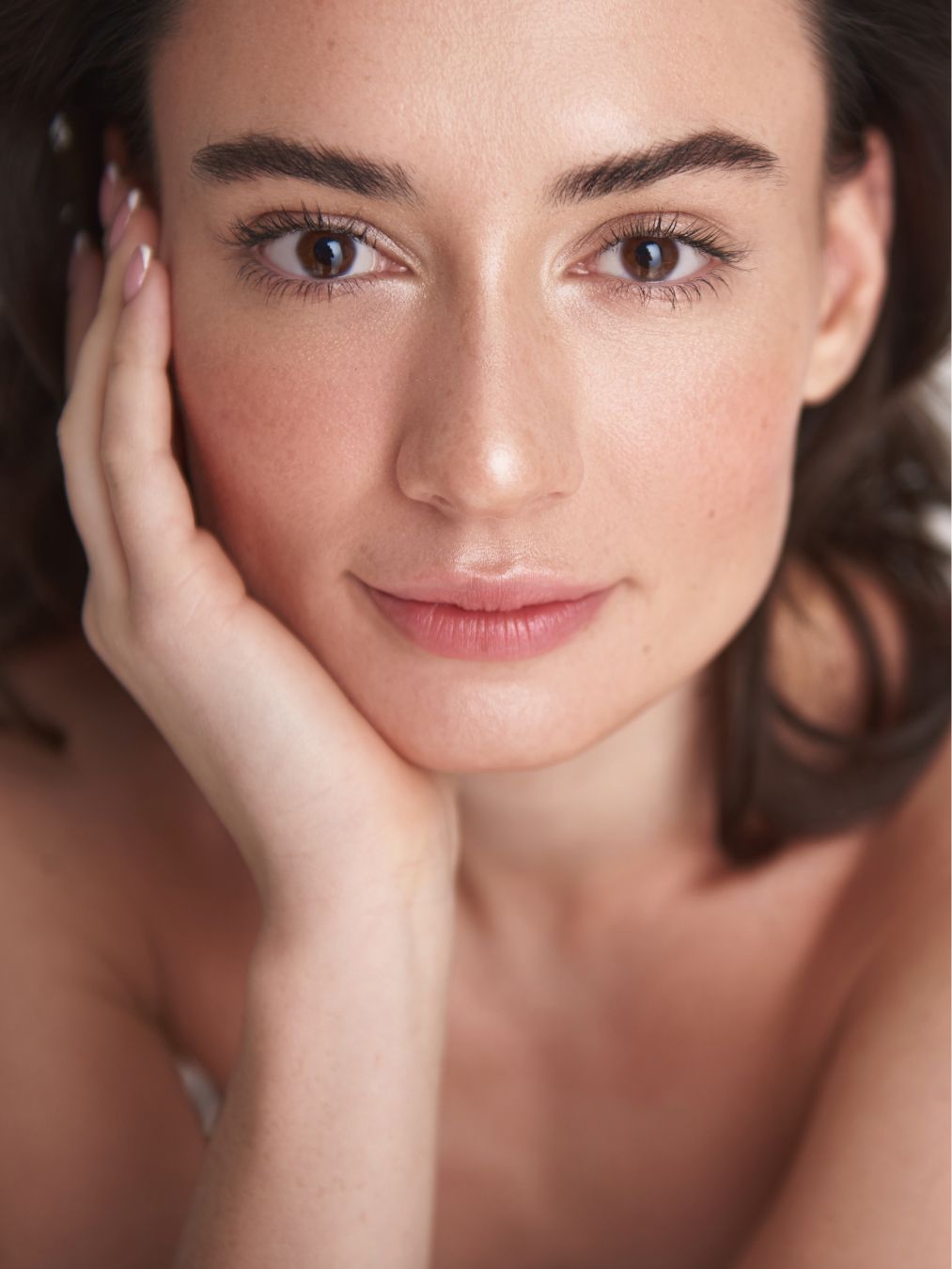 Close-up of a woman resting her face.