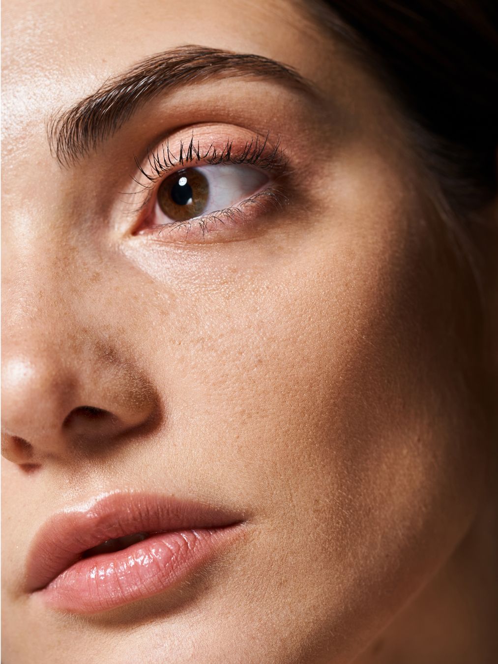 Close-up of a woman's eye and mouth.