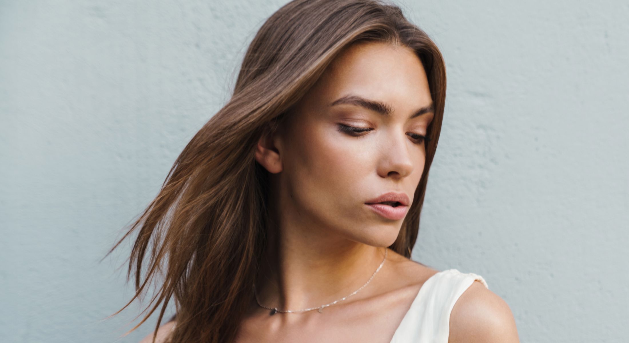 Young woman with long hair and natural makeup.