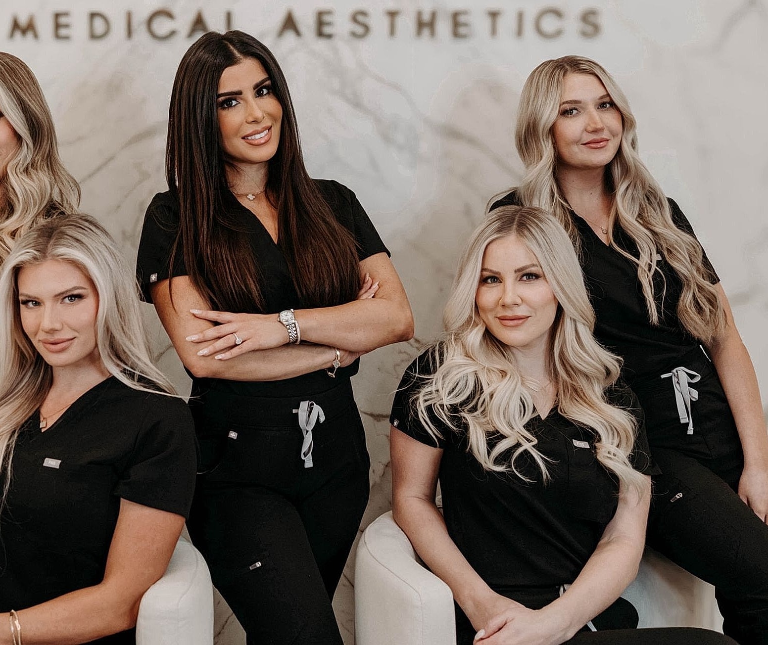 Group of women in medical aesthetics attire.